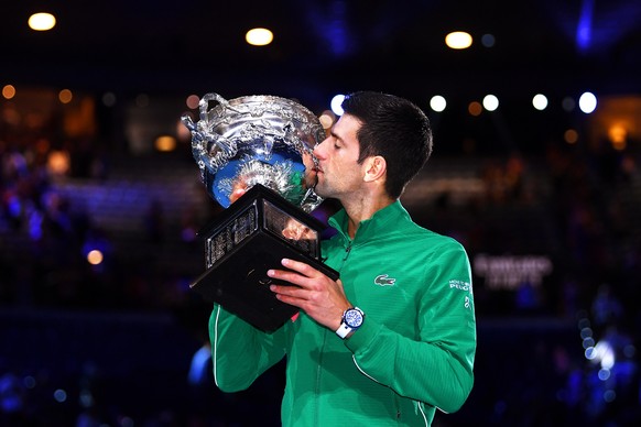 epa08187790 Novak Djokovic of Serbia kisses the Norman Brookes Challenge Cup trophy after winning the men&#039;s singles final against Dominic Thiem of Austria at the Australian Open Grand Slam tennis ...