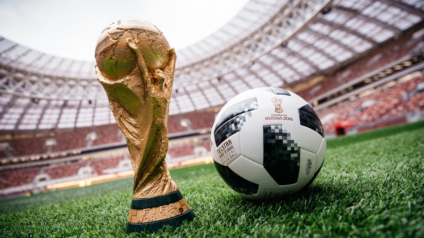 epa06320025 A handout photo made available by Adidas of the official match ball for the FIFA World Cup 2018 in Russia, named &#039;Telstar 18&#039;, and the FIFA World Cup trophy on the pitch of the L ...