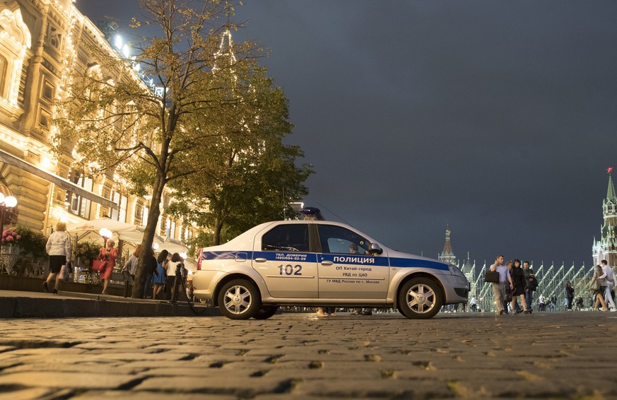 FILE - In this Wednesday, Sept. 13, 2017 file photo, a police car is parked in front of the GUM, State Shop, at Red square in Moscow, Russia. Moscow is grappling with a slew of fake bomb calls that ha ...