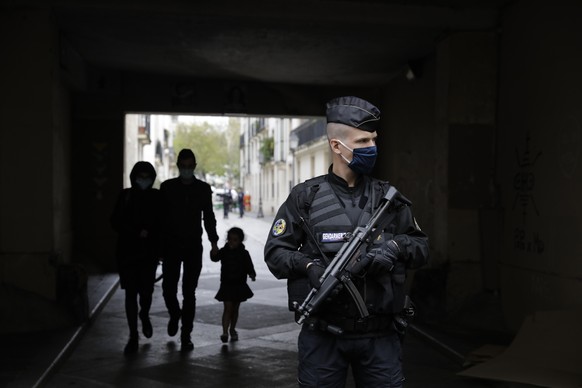 A French gendarme guards a street after a knife attack near the former offices of satirical newspaper Charlie Hebdo, Friday Sept. 25, 2020 in Paris. French terrorism authorities are investigating a st ...