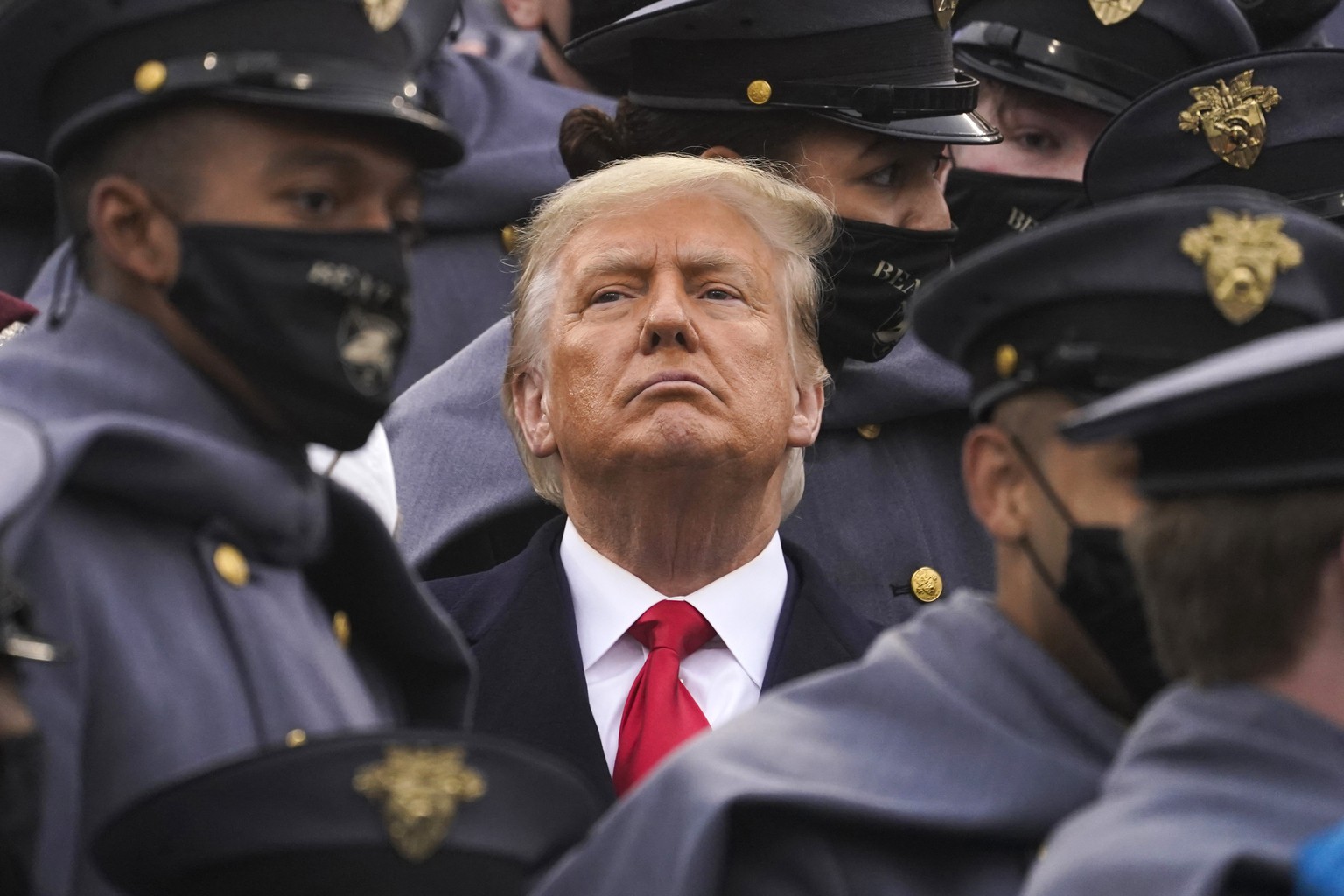 Surrounded by Army cadets, President Donald Trump watches the first half of the 121st Army-Navy Football Game in Michie Stadium at the United States Military Academy, Saturday, Dec. 12, 2020, in West  ...