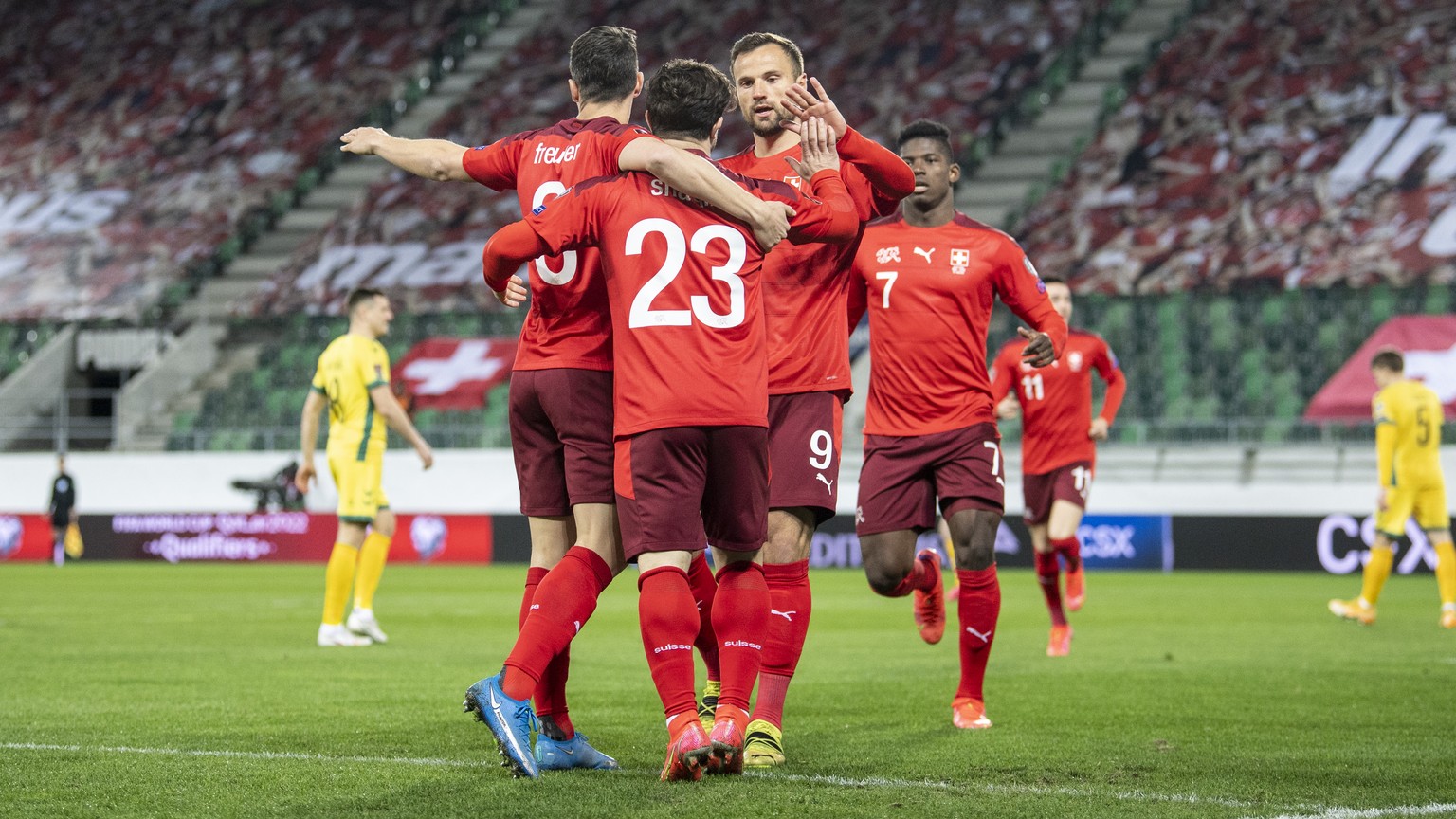 Swiss players Remo Freuler, left, and from right, Breel Embolo and Haris Seferovic, celebrate after Xherdan Shaqiri, center no 23, scored to 1:0 during the FIFA World Cup Qatar 2022 qualifying Group C ...