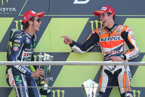 Italian MotoGP rider Valentino Rossi, left, and Spanish MotoGP rider Marc Marquez, right, celebrate on the podium of the MotoGP World Championship race at the Bugatti race track in Le Mans, western Fr ...