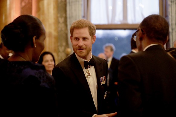 Britain&#039;s Prince Harry talks with guests during a reception after a receiving line for the Queen&#039;s Dinner for the Commonwealth Heads of Government Meeting (CHOGM) at Buckingham Palace in Lon ...