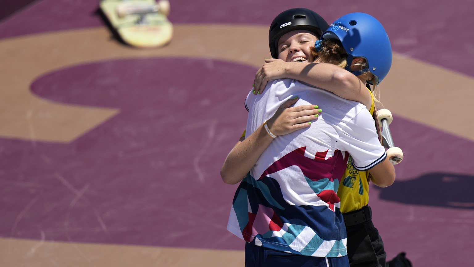 Bryce Wettstein of the United States embraces Poppy Starr Olsen of Australia during the women&#039;s park skateboarding prelims at the 2020 Summer Olympics, Wednesday, Aug. 4, 2021, in Tokyo, Japan. ( ...
