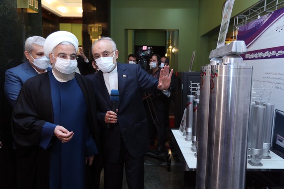 epa09126293 A handout picture made available by the Iranian presidential office shows Iranian President Hassan Rouhani (L) and head of Iran&#039;s nuclear organization Ali Akbar Salehi (R) visits an e ...