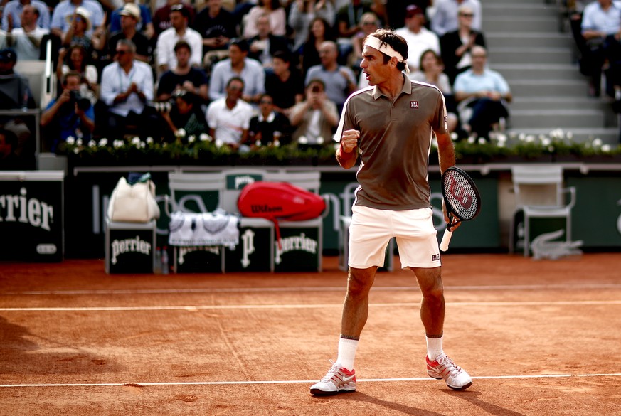 epa07625583 Roger Federer of Switzerland reacts as he plays Stan Wawrinka of Switzerland during their men’s quarter final match during the French Open tennis tournament at Roland Garros in Paris, Fran ...
