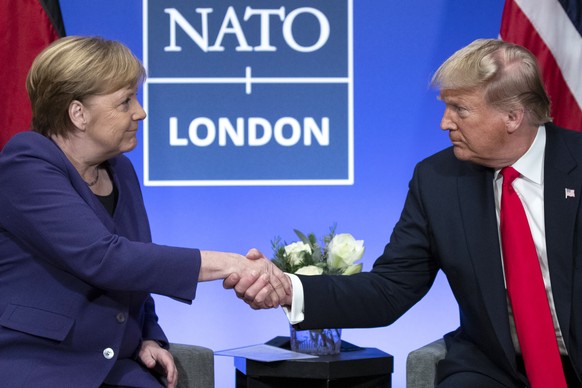 FILE - In this Wednesday, Dec. 4, 2019 file photo President Donald Trump Trump shakes hands with German Chancellor Angela Merkel during the NATO summit at The Grove in Watford, England. After more tha ...