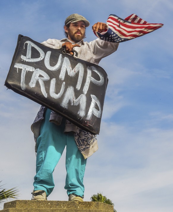 A protester demonstrates in an anti-Trump protest against President-elect, Donald Trump, that started at MacArthur Park and ended at the Edward Royal Federal Building in downtown Los Angeles, Saturday ...