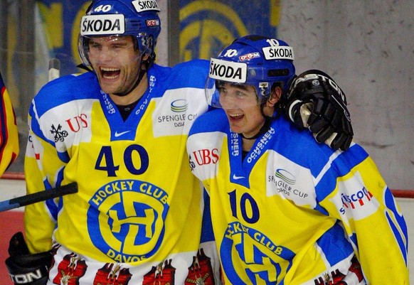 Swiss team HC Davos&#039; Andres Ambuehl, left, who scored the 4-1 reacts with Thierry Paterlini, during their play vs Finnish team Jokerit Helsinki, at the opening day of the Spengler Cup ice hockey  ...