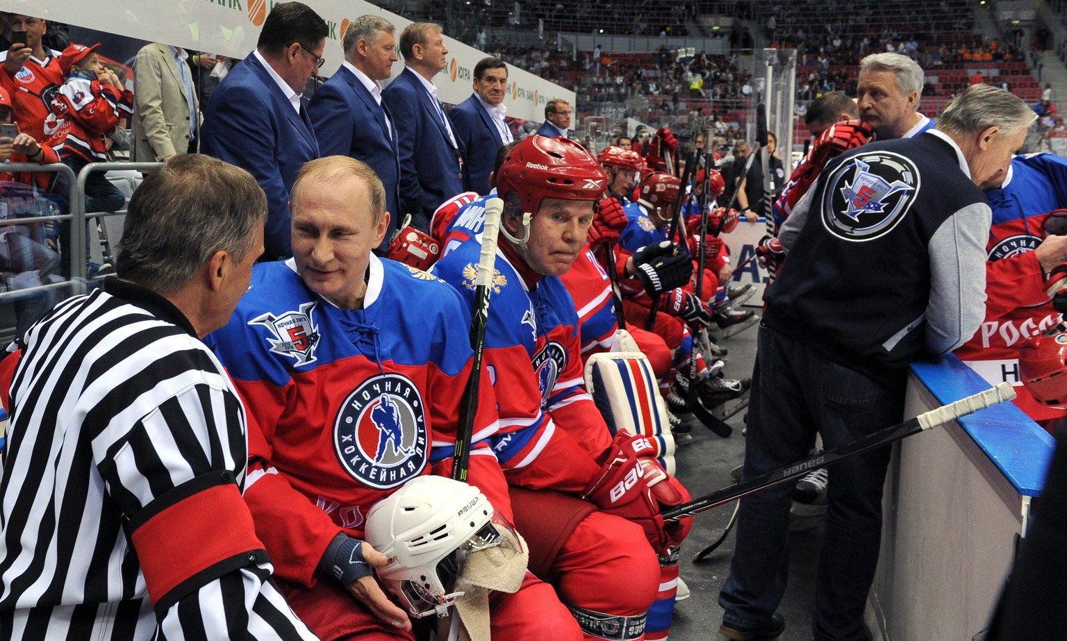 epa05298347 International Ice Hockey Federation (IIHF) President Rene Fasel (L) speaks with Russian President Vladimir Putin (2-L) as Night Hockey League Board Chairman Vyacheslav Fetisov (3-L) looks  ...