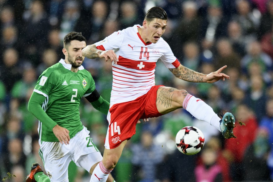 Northern Ireland&#039;s defender Conor McLaughlin, left, fights for the ball with Switzerland&#039;s midfielder Steven Zuber, right, during the 2018 Fifa World Cup play-offs first leg soccer match Nor ...