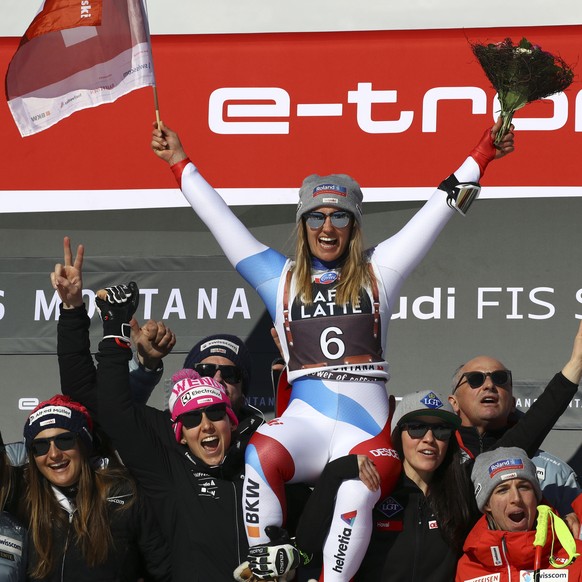 Second placed Switzerland&#039;s Joana Haehlen, top center, celebrates on the podium with teammates at the end of a women&#039;s World Cup downhill, in Crans Montana, Switzerland, Saturday, Feb. 23, 2 ...