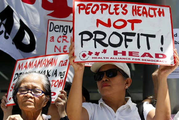 FILE - In this Monday, March 5, 2018 file photo, protesters display placards during a rally at the Sanofi Pasteur office in suburban Taguig city to protest the drug company&#039;s deal with the Govern ...