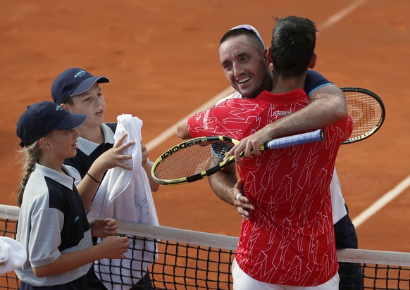 In this Saturday, June 13, 2020 photo, Serbia&#039;s Novak Djokovic, front right, hugs with Serbia&#039;s Viktor Troicki after their match of the Adria Tour charity tournament in Belgrade, Serbia. Nov ...