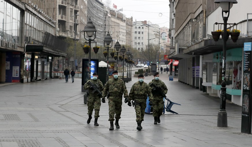 In this March 26, 2020, photo, Serbian army soldiers patrol in Belgrade&#039;s main pedestrian street, in Serbia. In the ex-communist Europe and elsewhere, rulers are assuming more power while they in ...