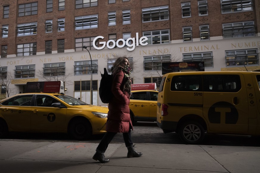 FILE - In this Dec. 17, 2018, file photo a woman walks past Google offices in New York. Alphabet Inc., parent company of Google, reports financial earnings on Thursday, July 25, 2019. (AP Photo/Mark L ...