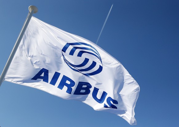 epa07749972 (FILE) - A plane flies over an Airbus flag on the day of the group annual press conference on the 2018 financial results, in Blagnac, Southern France, 14 February 2019 (reissued 31 July 20 ...