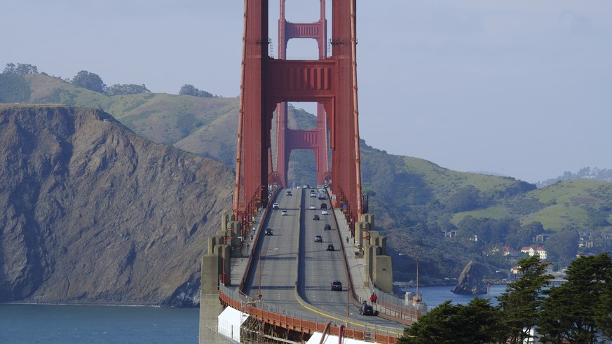In this photo taken Friday, March 27, 2020, light evening commuter traffic flows over the Golden Gate Bridge in San Francisco. An iconic San Francisco landmark is in trouble. Traffic on the Golden Gat ...