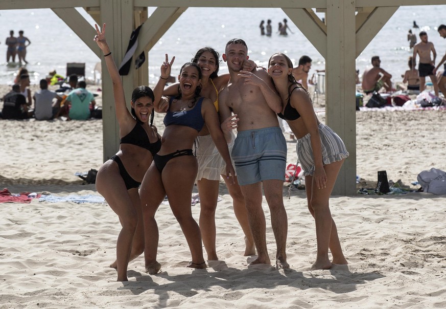 epa08434376 Israelis enjoy a sunny day on the beach of Tel Aviv, Israel, 20 May 2020, amid the ongoing coronavirus COVID-19 pandemic. The beaches of Tel Aviv were officially re-opened for the public a ...