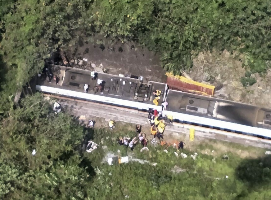In this photo released by National Fire Agency, rescue workers are seen near the site of a partial train derailment in Toroko Gorge in Taiwan&#039;s eastern Hualian region, Friday, April 2, 2021. The  ...