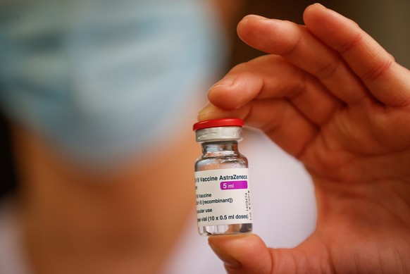 epa08996132 A member of the medical staff holds a vial of the AstraZeneca-Oxford Covid-19 vaccine at the South Ile-de-France Hospital Group (Groupe Hospitalier Sud Ile-de-France), in Melun, on the out ...