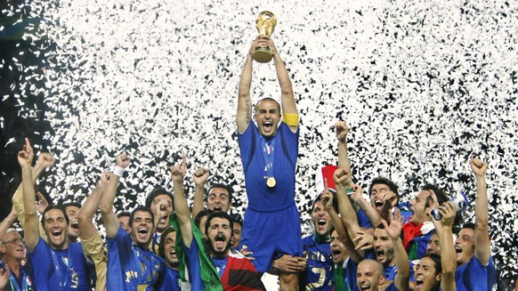 FILE - In this Sunday, July 9, 2006 file photo Fabio Cannavaro lifts the soccer World Cup trophy after Italy defeated France in the final in the Olympic Stadium in Berlin, Germany. The World Cup was i ...