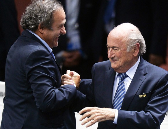 epa05077573 (FILE) A file picture dated 29 May 2015 of FIFA President Joseph Blatter (R) being congratulated by UEFA President Michel Platini (L) after his election as FIFA president during the 65th F ...