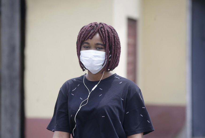 A woman wearing a face mask walks at the Yaba Mainland hospital where the first Nigerian victims of the COVID-19 virus are being treated in Lagos Nigeria Friday, Feb. 28, 2020. Nigeria&#039;s health a ...