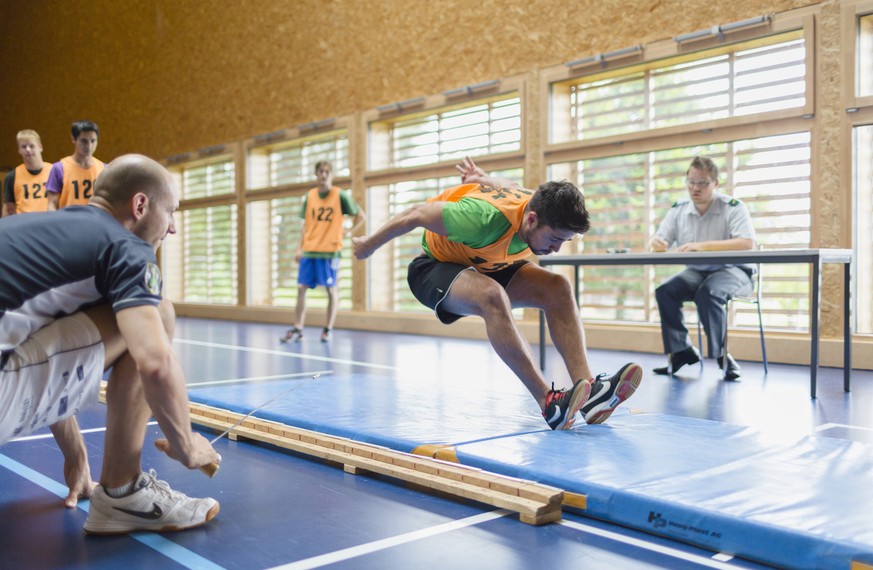 During the sports exam, a young man does the standing long jump, where he jumps from the gym floor onto a mat and where the distance between the jump line and the body&#039;s rearmost point of contact ...