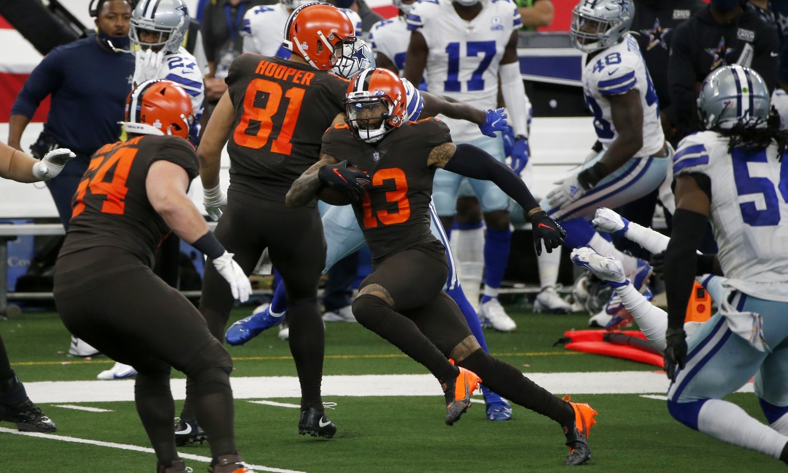Cleveland Browns wide receiver Odell Beckham Jr. (13), makes his way through Dallas Cowboys defenders, past center JC Tretter (64) and Austin Hooper (81) on his way to the end zone for a touchdown lat ...