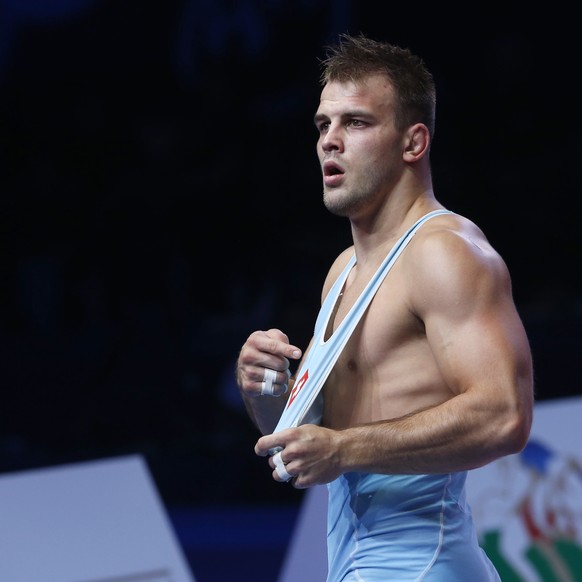 Stefan Reichmuth, of Switzerland, celebrates his victory over Carlos Arturo Izquierdo Mendez, of Columbia, in their bronze match of the men&#039;s 86 kg category during the Wrestling World Championshi ...