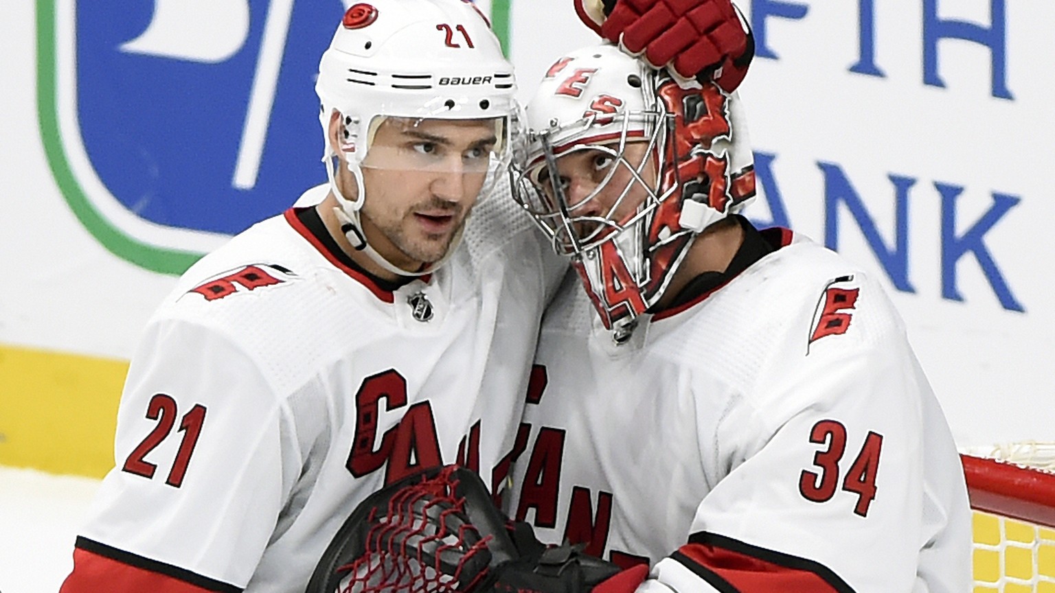 Carolina Hurricanes goaltender Petr Mrazek (34), of the Czech Republic, is congratulated by right wing Nino Niederreiter (21), of Switzerland, after the team&#039;s win against the Nashville Predators ...