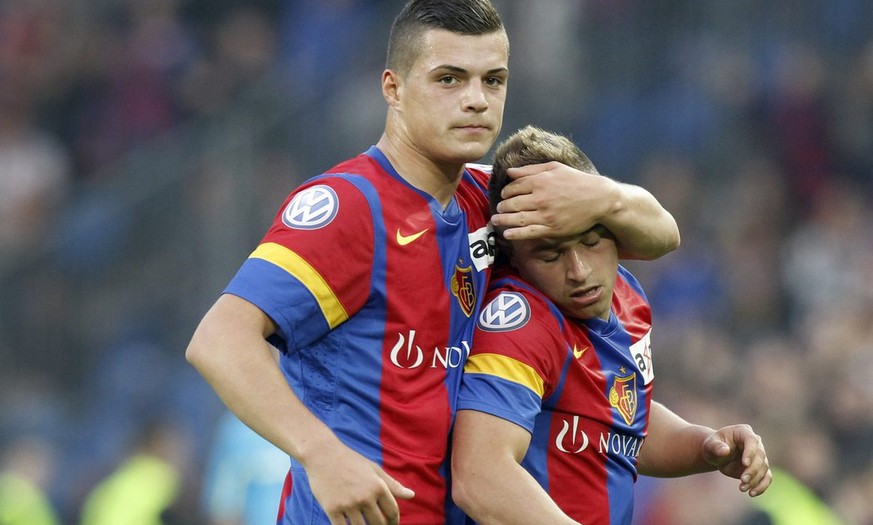 Basel&#039;s Granit Xhaka, left, holds Xherdan Shaqiri, right, during the Super League soccer match between FC Basel and BSC Young Boys at the St. Jakob-Park stadium in Basel, Switzerland, on Wednesda ...