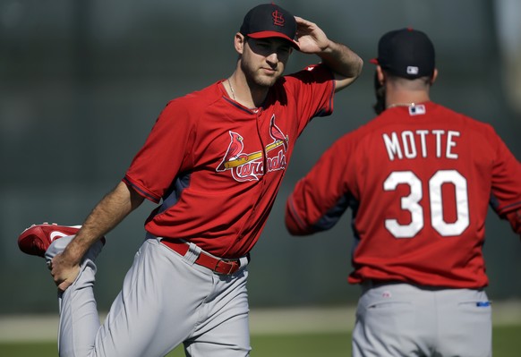 St. Louis Cardinals pitchers Michael Wacha, left, and Jason Motte talk as they stretch at the start of spring training baseball practice Saturday, Feb. 15, 2014, in Jupiter, Fla. (AP Photo/Jeff Robers ...