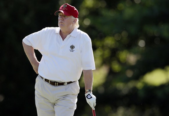 FILE - In this June 27, 2012, file photo, Donald Trump stands on the 14th fairway during a pro-am round of the AT&amp;T National golf tournament at Congressional Country Club in Bethesda, Md. A set of ...