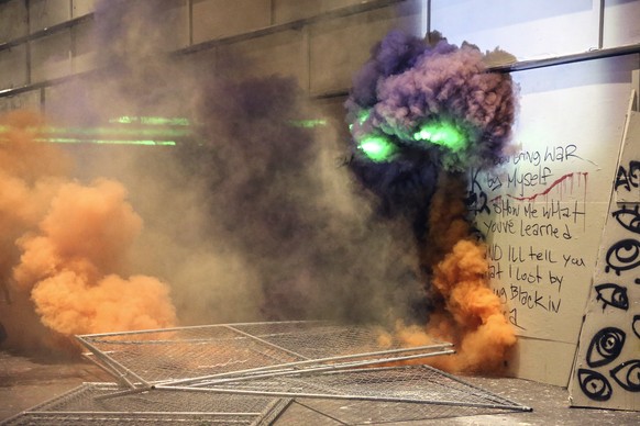 Smoke fills the street as police respond to protesters during a demonstration, Friday, July 17, 2020 in Portland, Ore. Militarized federal agents deployed by the president to Portland, fired tear gas  ...