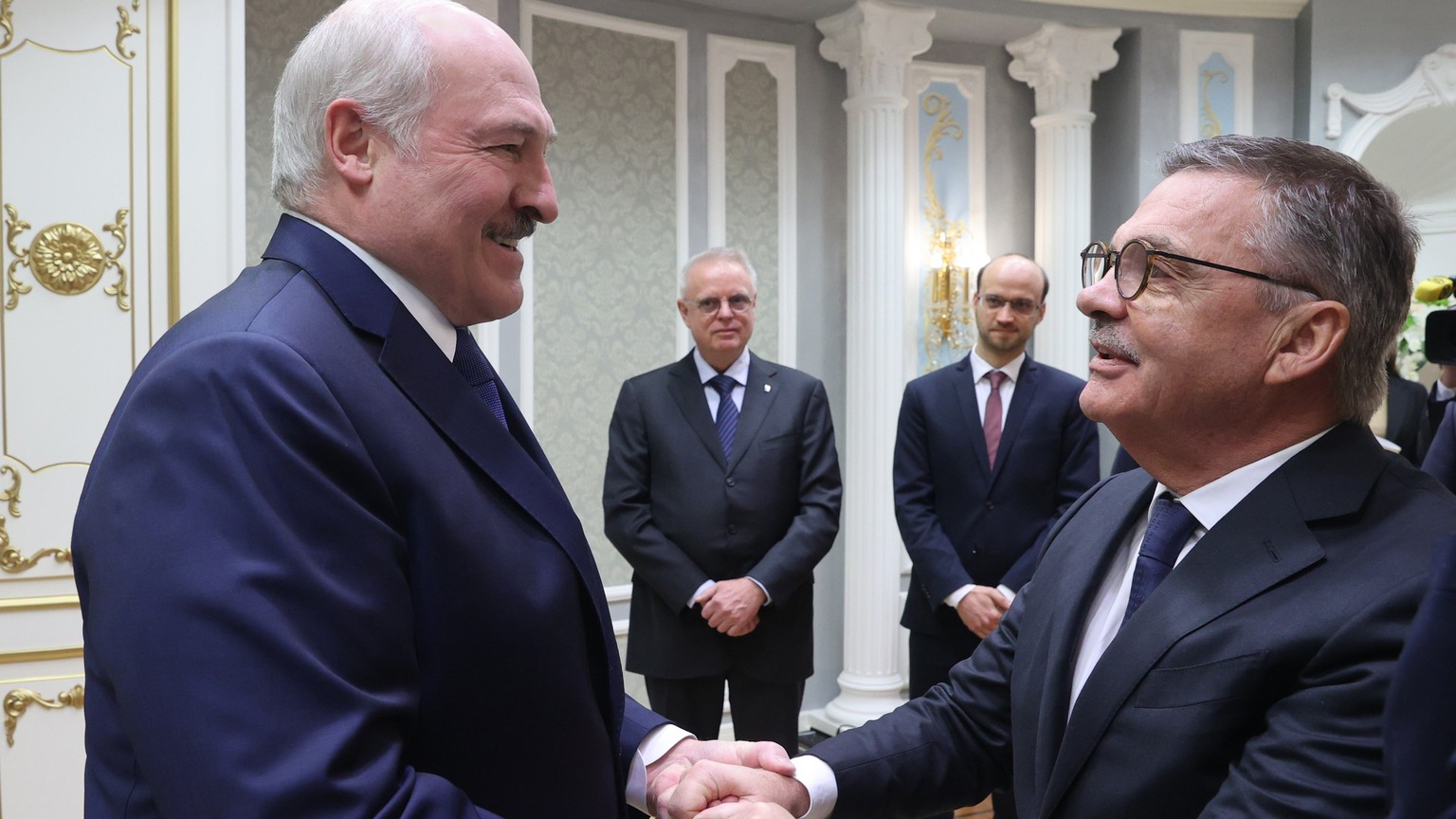 epa08931007 Belarusian President Alexander Lukashenko (L) shakes hands with Rene Fasel (R), the president of the International Ice Hockey Federation (IIHF), in Minsk, Belarus, 11 January 2021. EPA/NIK ...