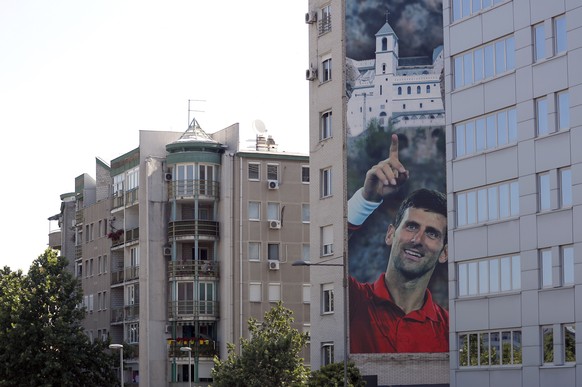 A billboard depicting Serbian tennis player Novak Djokovic and the Christian Orthodox monastery of Ostrog is seen on a building in Belgrade, Serbia, Wednesday, June 24, 2020. Djokovic has tested posit ...