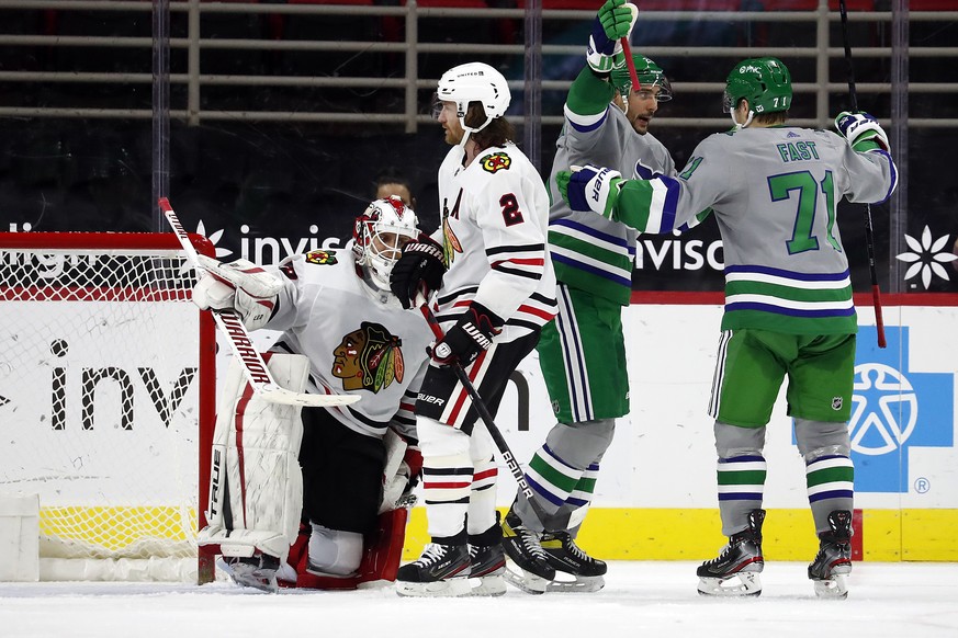 Carolina Hurricanes&#039; Nino Niederreiter (21) celebrates his goal with teammate Jesper Fast (71) with Chicago Blackhawks&#039; Duncan Keith (2) and goaltender Kevin Lankinen (32) nearby during the  ...