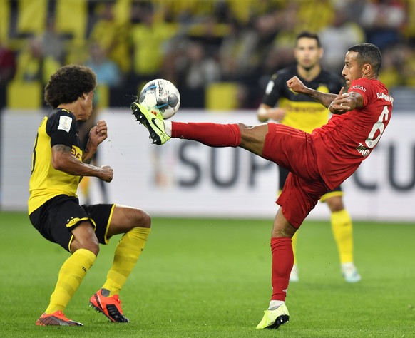 Bayern&#039;s Thiago, right, duels for the ball with Dortmund&#039;s Axel Witsel during the German Supercup final soccer match between Borussia Dortmund and Bayern Munich in Dortmund, Germany, Saturda ...
