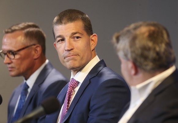 Julien BriseBois, center, listens between Steve Yzerman, left, and Chairman and Governor Jeff Vinik during an NHL hockey news conference, Tuesday, Sept. 11, 2018, in Tampa, Fla., where Yzerman announc ...