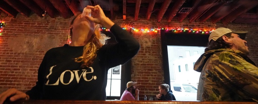 Allison Richter drinks her free shot at the bar, after receiving the Moderna COVID-19 vaccine, during a vaccine event hosted by Nola Ready, where people get a free drink at the bar if they received a  ...