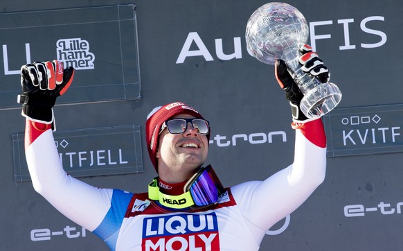 epa08276358 Overall winner of the downhill World Cup, Beat Feuz from Switzerland, celebrates with the trophy on the podium after the FIS Alpine Skiing World Cup Men&#039;s Downhill in Kvitfjell, Norwa ...