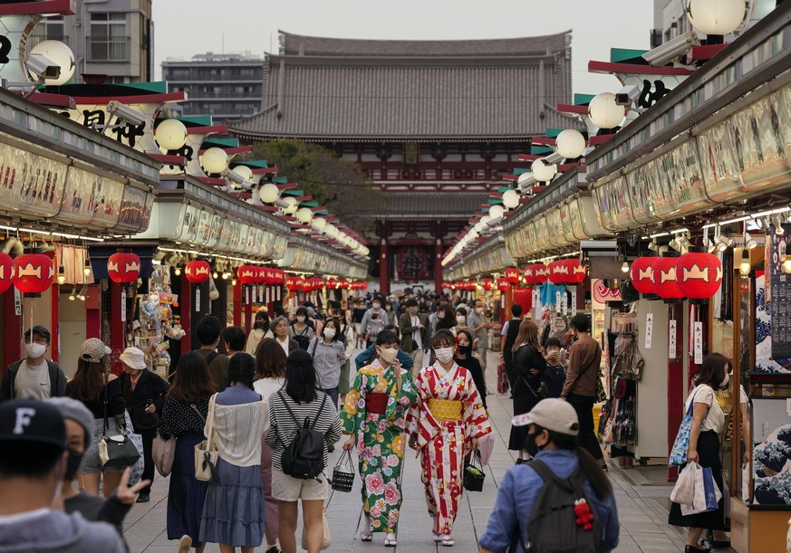 epa08711652 Visitors walk through Nakamise Street to Sensoji temple, at dusk at Asakusa, downtown Tokyo, Japan, 30 September 2020 (issued 01 October 2020). Japan started easing entry restrictions to v ...