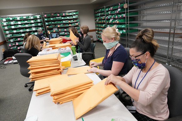 Lehigh County workers count ballots as vote counting in the general election continues, Friday, Nov. 6, 2020, in Allentown, Pa. (AP Photo/Mary Altaffer)