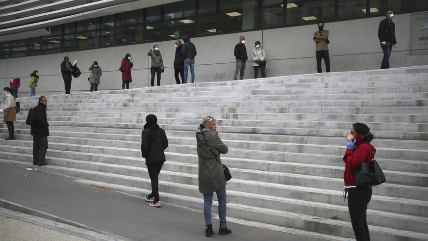 People wait in line to get a coronavirus test outside the La Timone hospital in Marseille, southern France, Monday March 23, 2020. For most people, the new coronavirus causes only mild or moderate sym ...