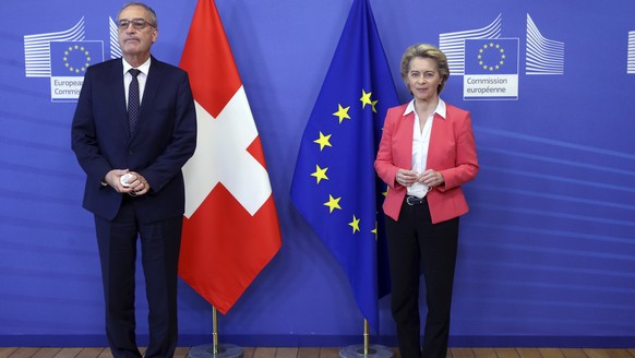 European Commission President Ursula Von der Leyen, right, greets Swiss President Guy Parmelin prior to a meeting at EU headquarters in Brussels, Friday, April 23, 2021. (Francois Walschaerts, Pool vi ...