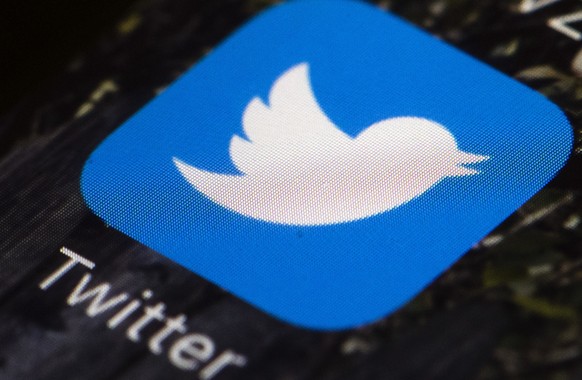 FILE - This April 26, 2017, file photo shows the Twitter app icon on a mobile phone in Philadelphia. Twitter and Pinterest are taking new steps to root out voting misinformation designed to suppress p ...