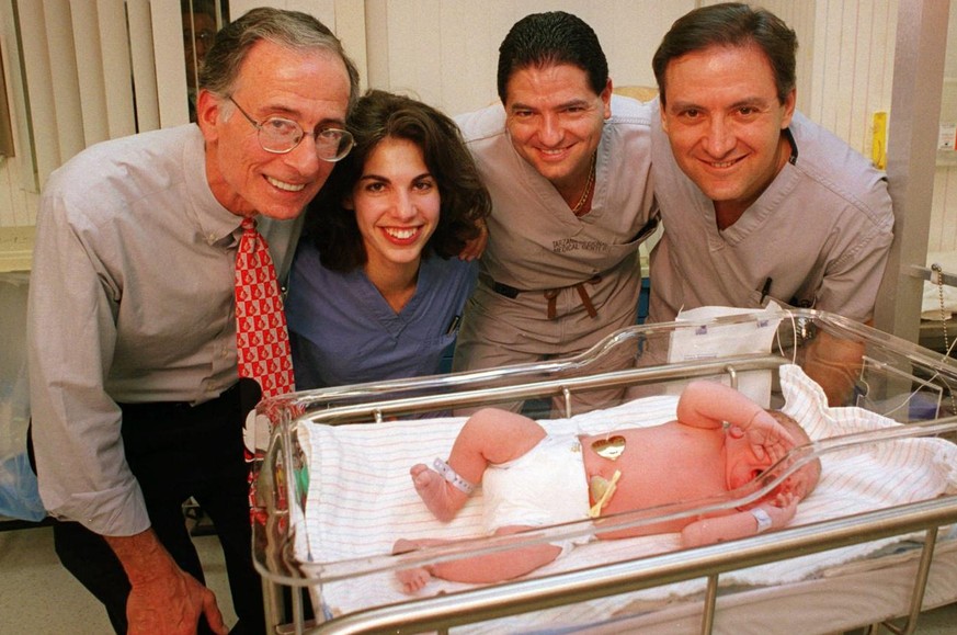 A team of physicians, from left, Robert Barnhard, Snunit Ben-Ozer, Mark Karalla and Michael Vermesh, from the Encino-Tarzana Regional Medical Center, stand over a newborn baby boy developed from an em ...